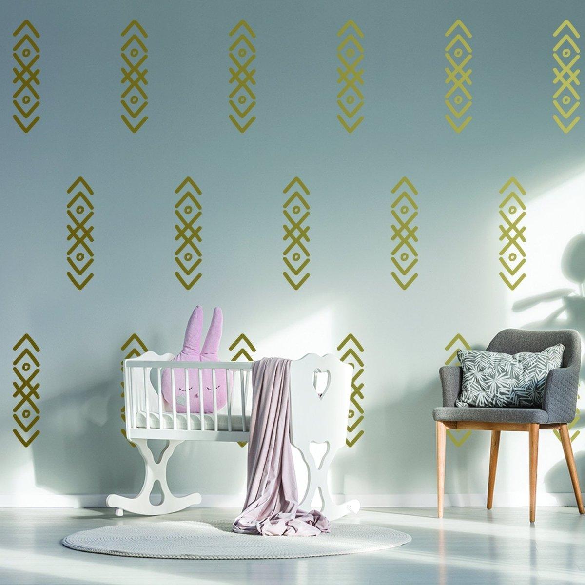 Stylish nursery with gold arrow wall stickers, crib, plush bunny, and cozy decor accents.