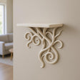 3D printed vine wall shelf mounted on a beige wall, featuring elegant curling tendrils for a nature-inspired decor.