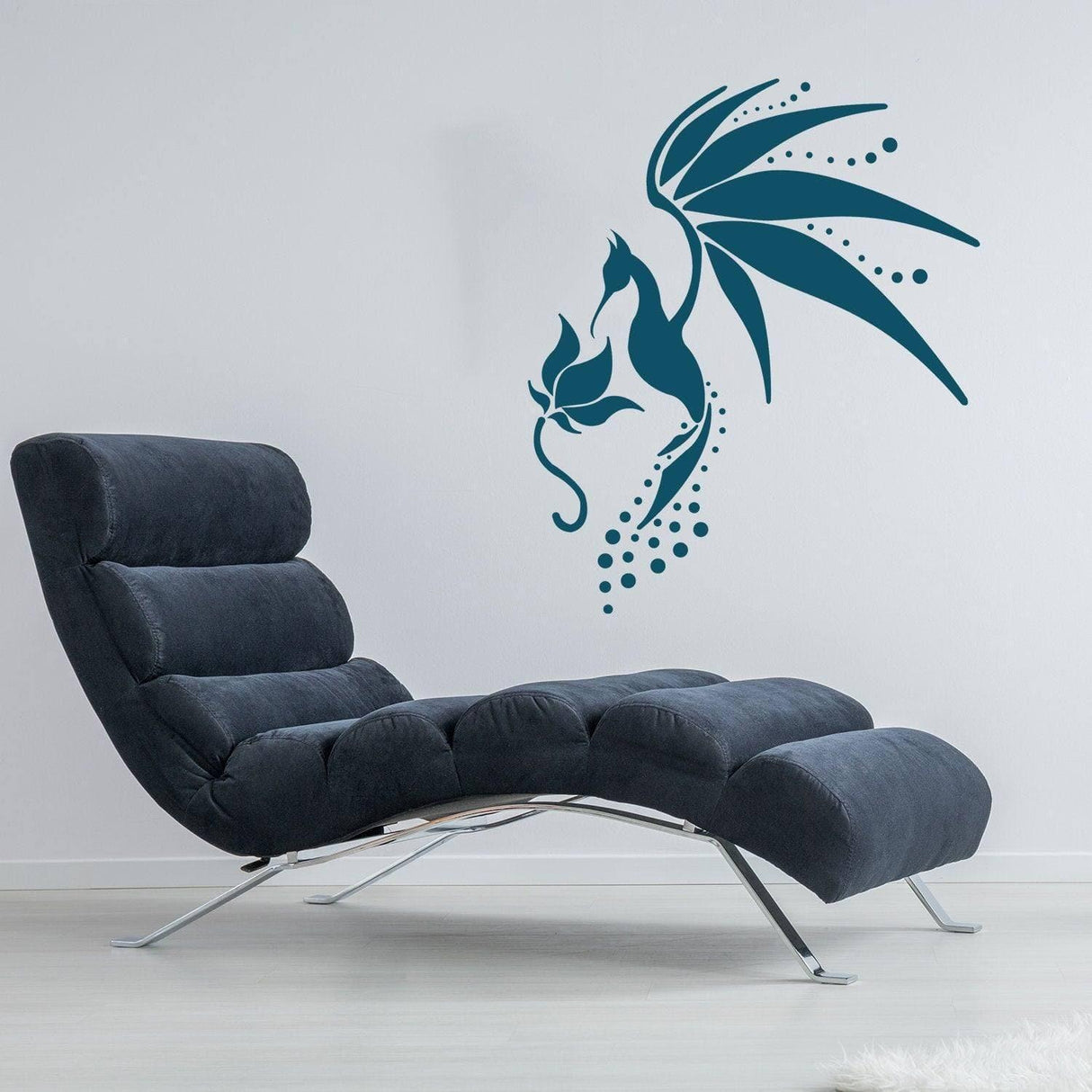 Stylish hummingbird wall decal above a modern black lounge chair in a contemporary living space.