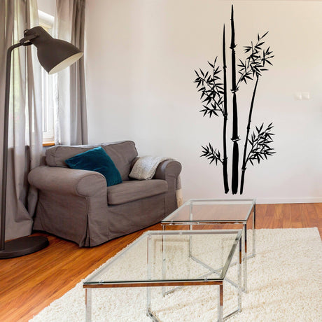 Bamboo wall art sticker in a cozy living room with a gray couch and glass coffee table.