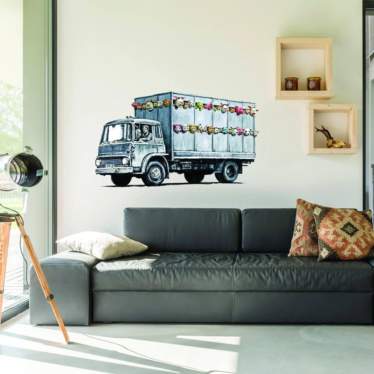 Banksy animal truck vinyl wall sticker adding style to a modern living room with a comfy sofa.