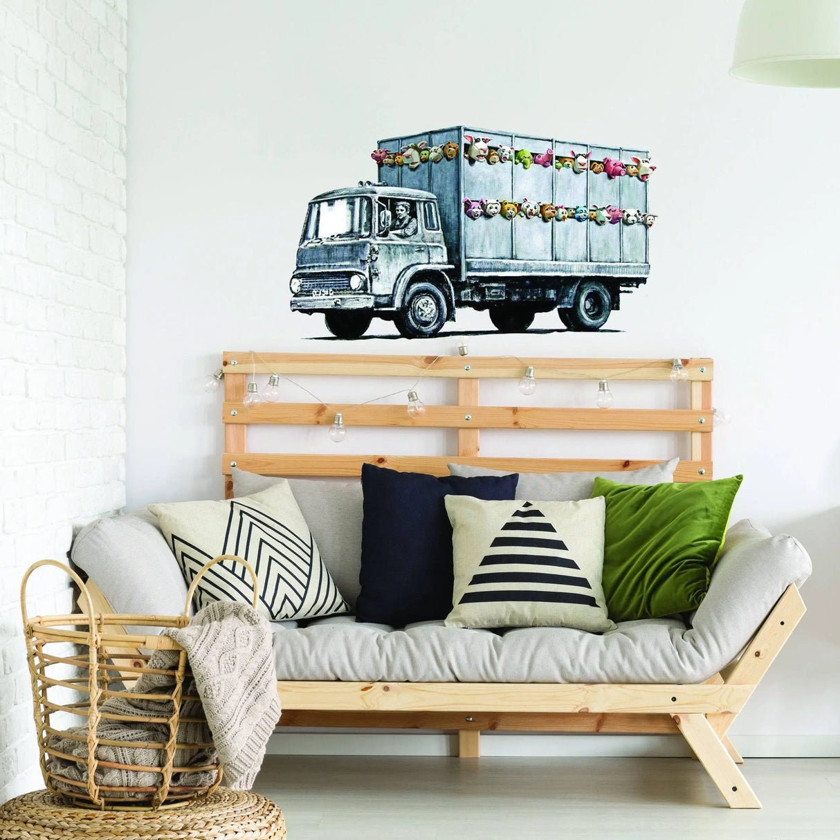 Banksy Animal Truck Vinyl Wall Sticker on wall above a stylish sofa, enhancing home decor with vibrant art.