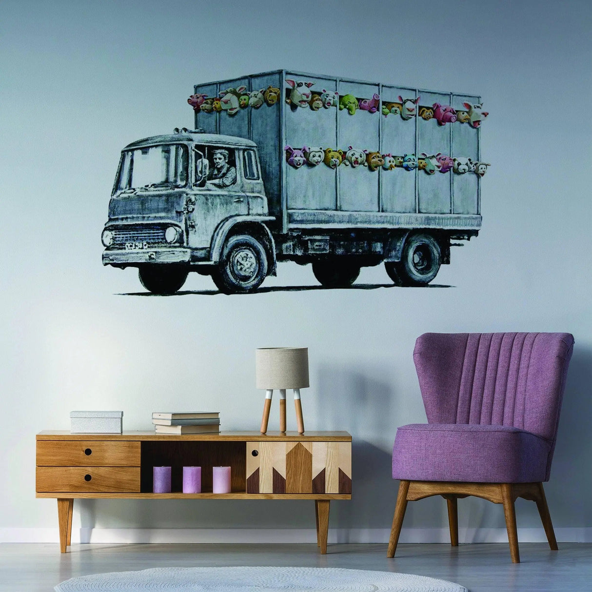 Banksy animal truck wall sticker on a stylish wall with purple chair and modern decor.