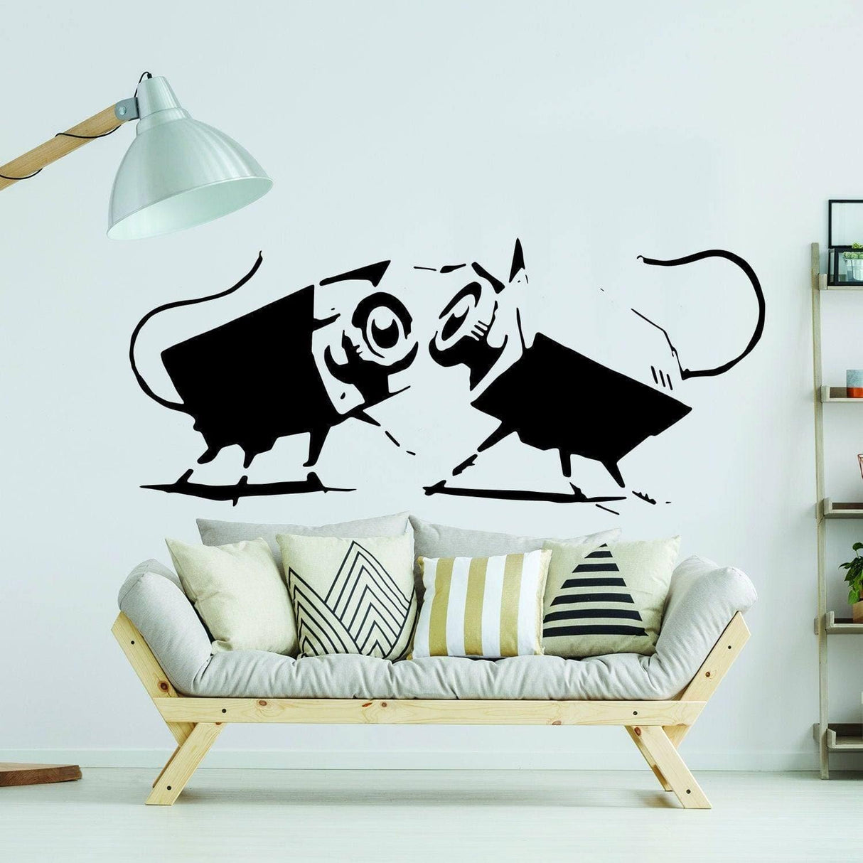 Urban Expressions vinyl wall art sticker featuring playful black cats on a white wall above a modern sofa.