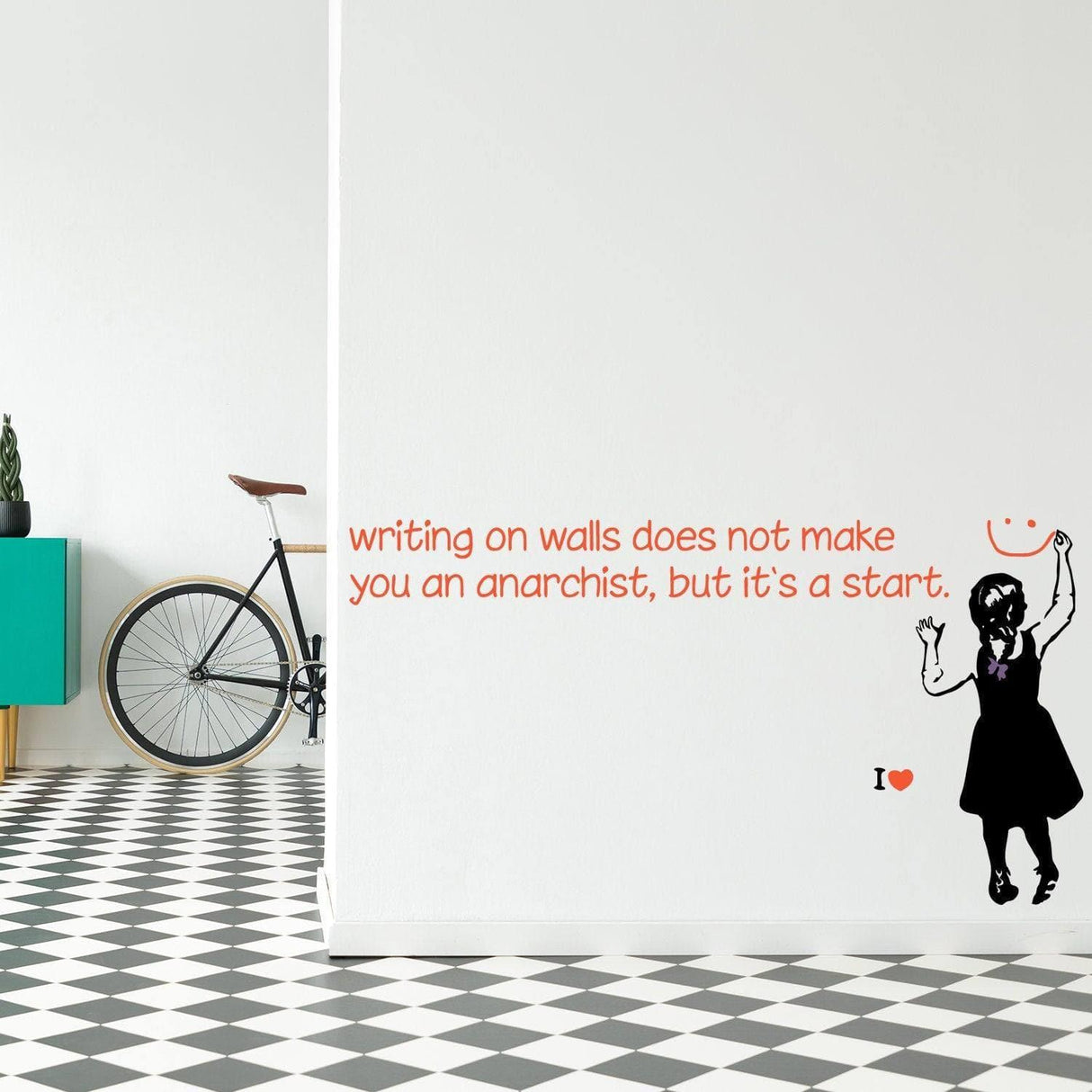 Edgy wall sticker with quote 'writing on walls does not make you an anarchist, but it's a start' in modern home decor.