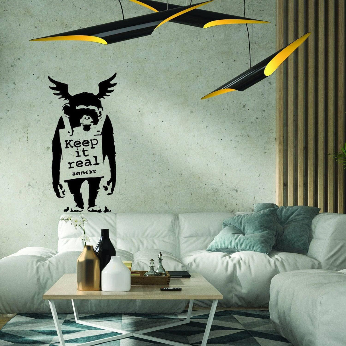 Banksy monkey graffiti wall sticker with 'Keep it real' text on urban living room wall.