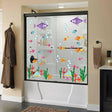 Colorful underwater scene vinyl decals on a shower door, featuring fish and bubbles for playful bathroom decor.