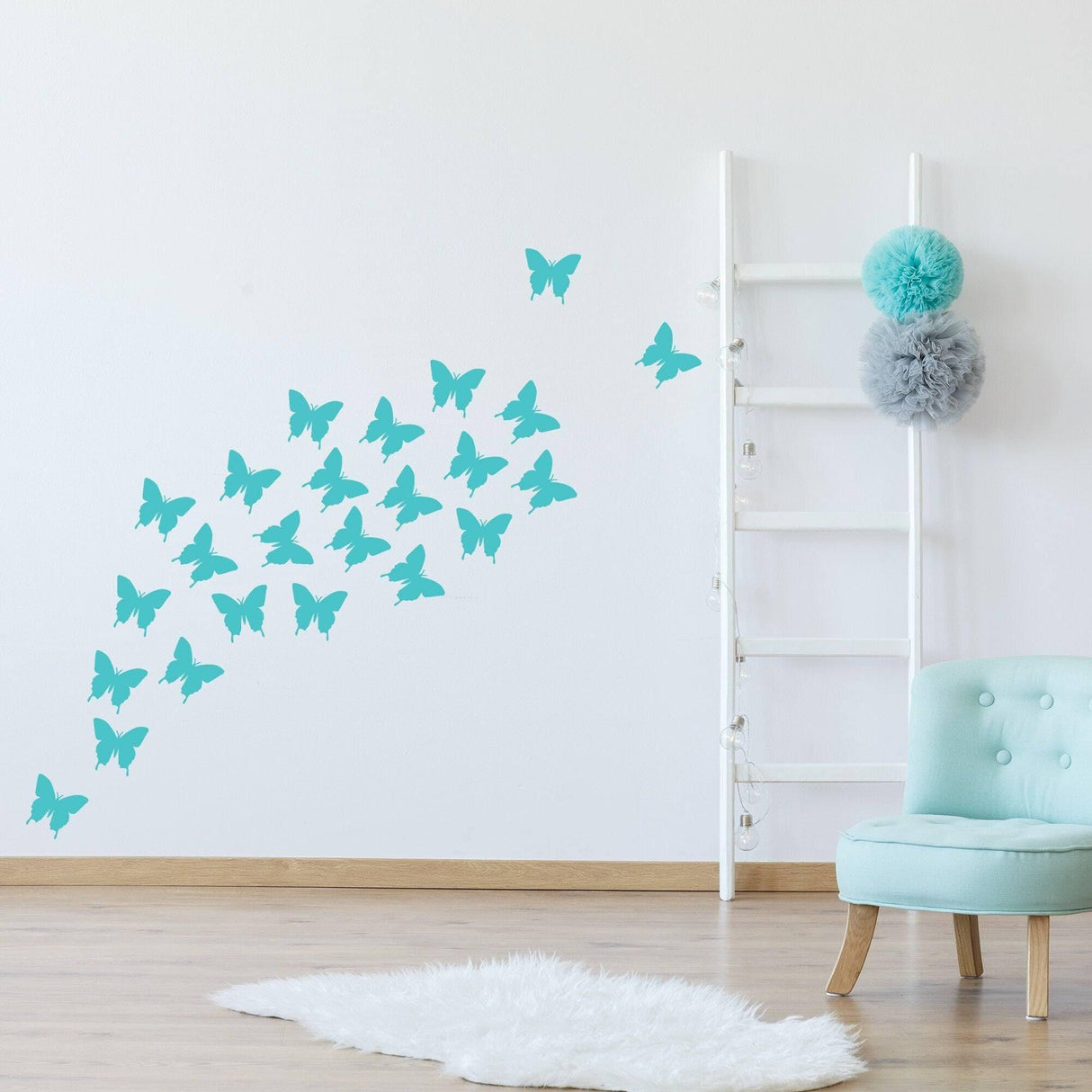 Turquoise butterfly wall decals in a stylish interior with a ladder and chair, creating a vibrant decor atmosphere.