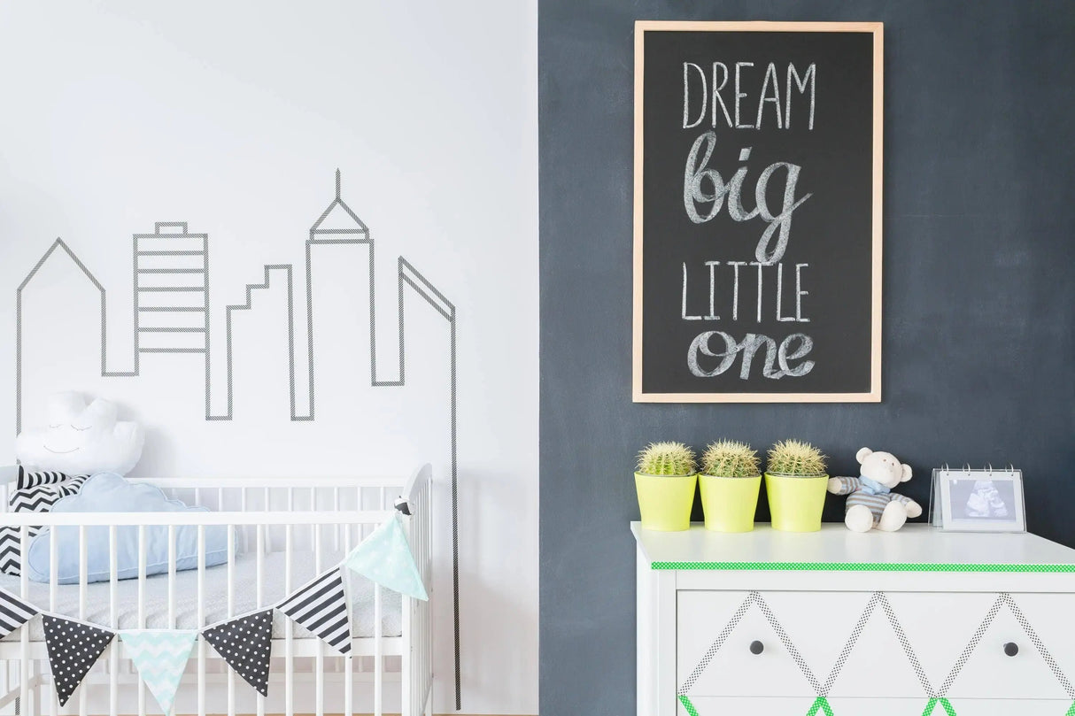 Nursery featuring a chalkboard wall with the phrase 'Dream big little one' and stylish decor elements.