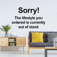 Creative vinyl wall decal with 'Sorry! The lifestyle you ordered is currently out of stock' quote in stylish living room decor.
