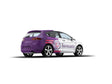 Custom car decal half wrap vinyl on a stylish race-ready vehicle, displaying a sleek design in purple and white.