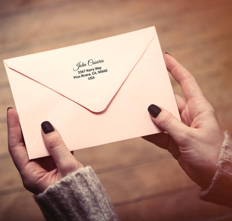 Custom clear mailing label on a pink envelope, featuring personalized address for stylish postage.