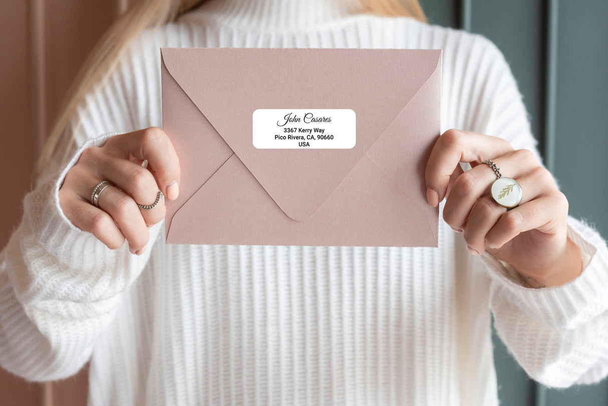 Custom clear mailing label on a pink envelope, showcasing personalized address with stylish font.