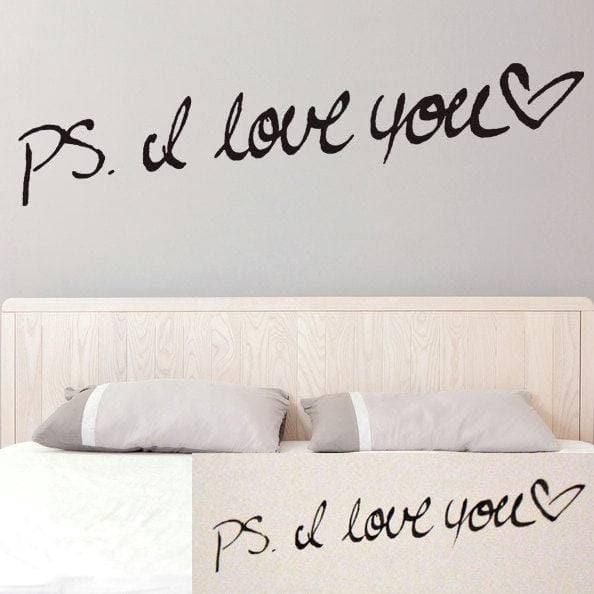 Personalized wall decal with the phrase 'PS. I love you' in handwritten style above a bed.