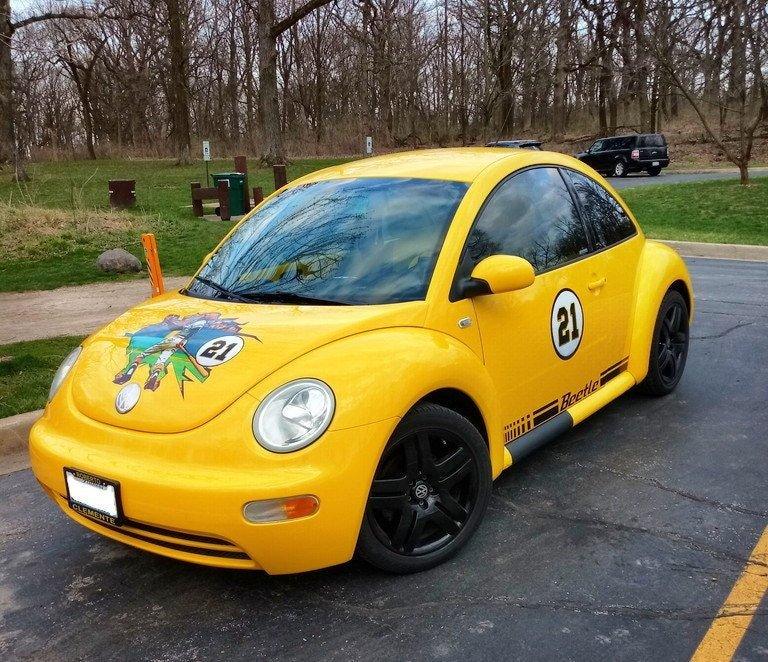 Custom yellow racing Volkswagen Beetle with unique graphics and number 21 on the side.