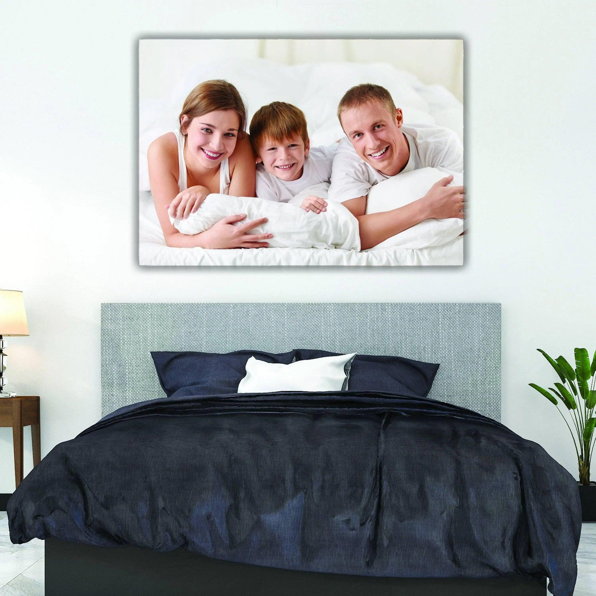 Family portrait on canvas above a cozy bed, adding a personal touch to home decor.