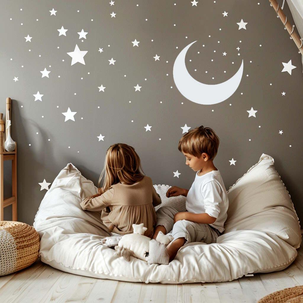 Children sitting on a cozy beanbag in front of a wall decorated with white stars and a crescent moon.