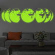 Glow in the dark moon phases wall art illuminating a cozy living room.