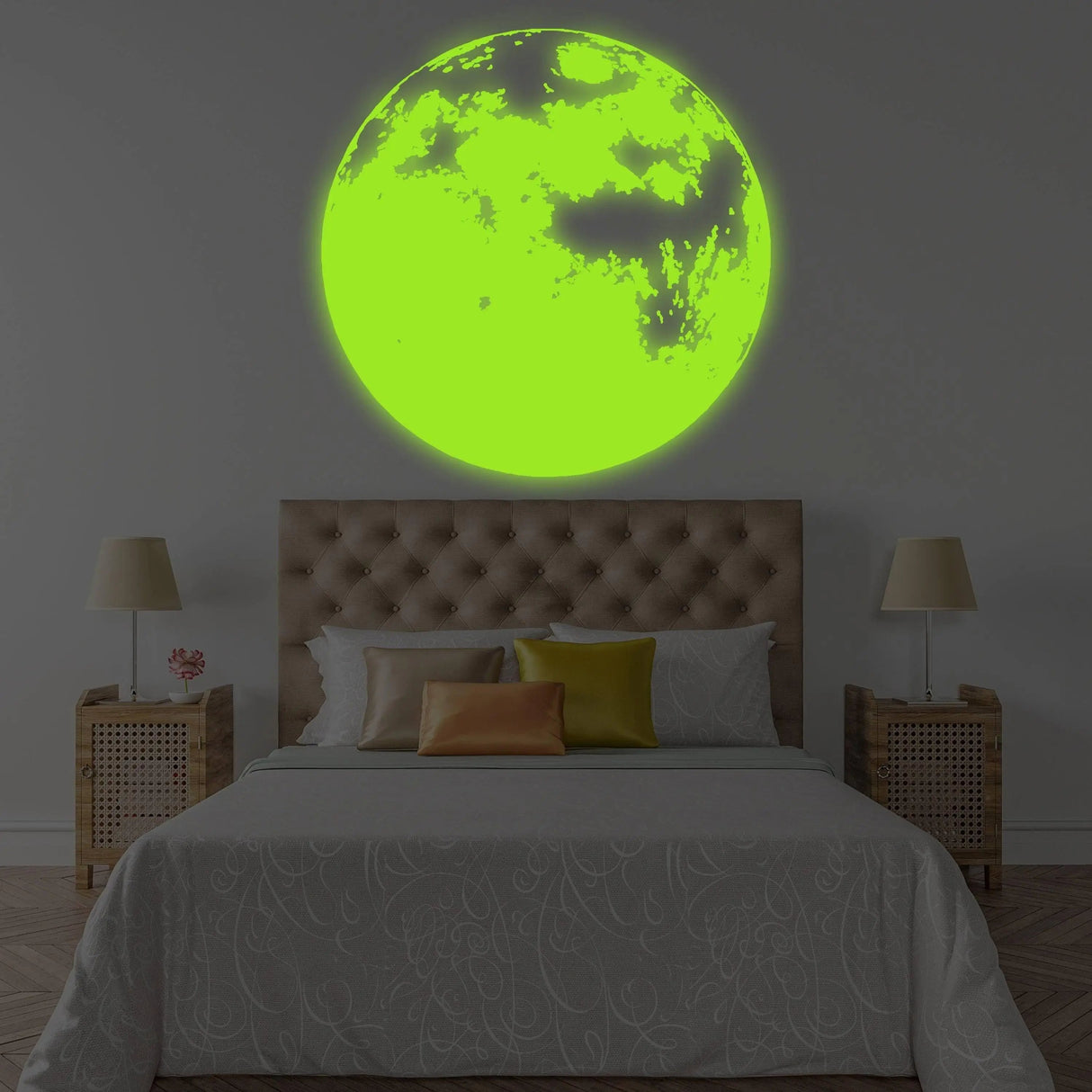 Glow-in-the-dark moon wall decal illuminating a child's bedroom with vibrant green light.