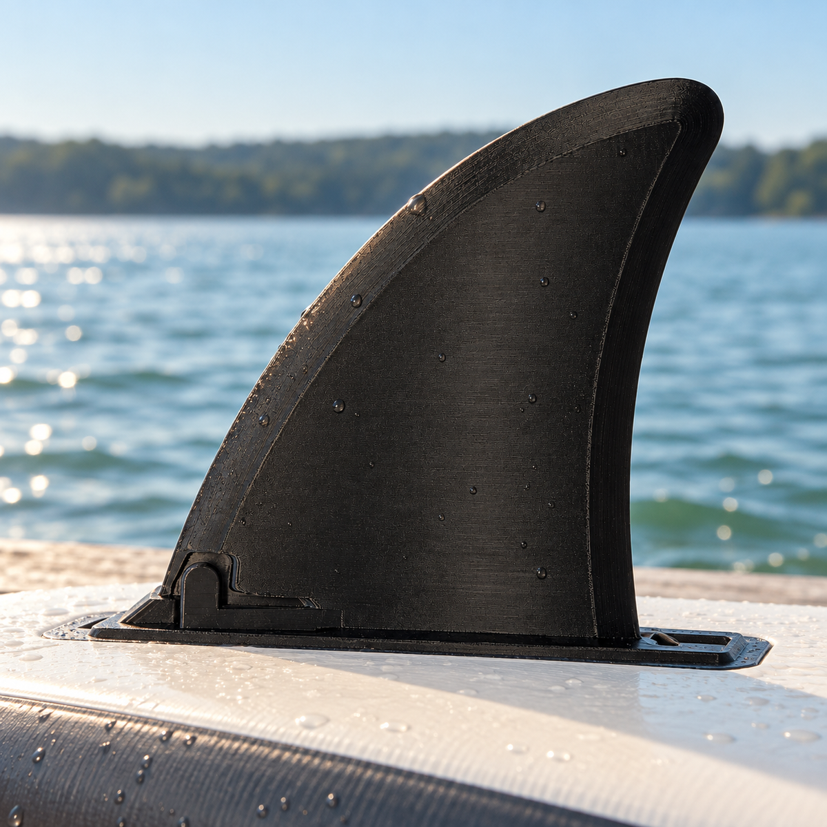 Illustrative lakeside view of the black replacement paddleboard fin on an inverted SUP board