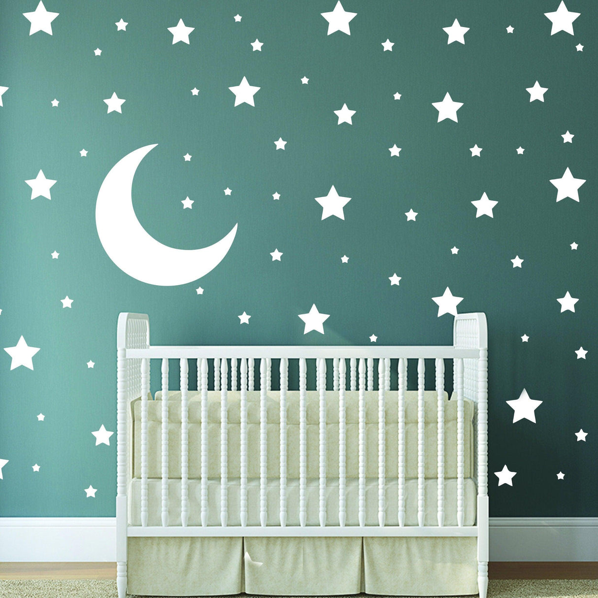 White stars and moon wall stickers in a nursery with a crib, creating a calming night sky atmosphere.