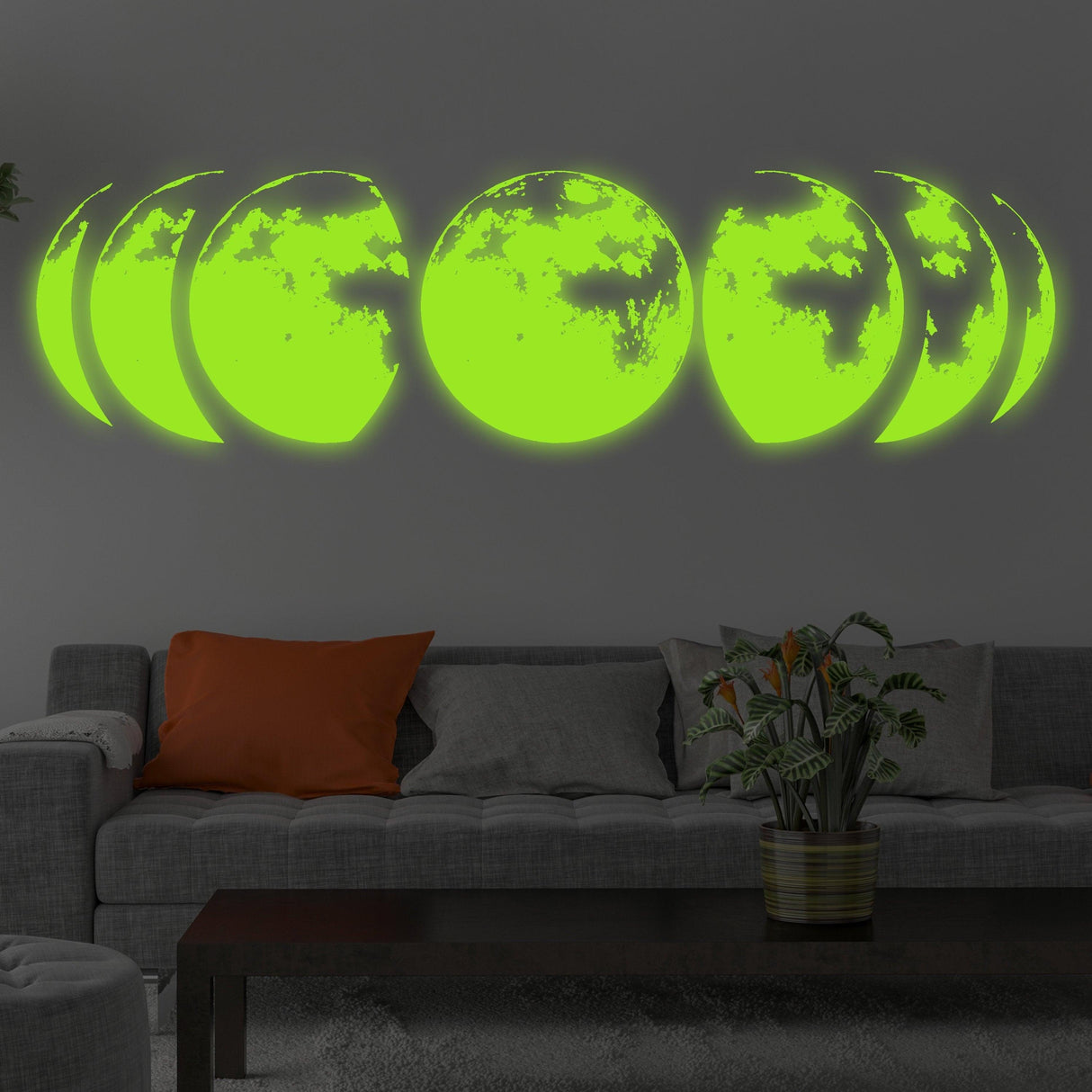 Glow-in stickers creating a bright moon phase design on a living room wall, glowing in the dark.