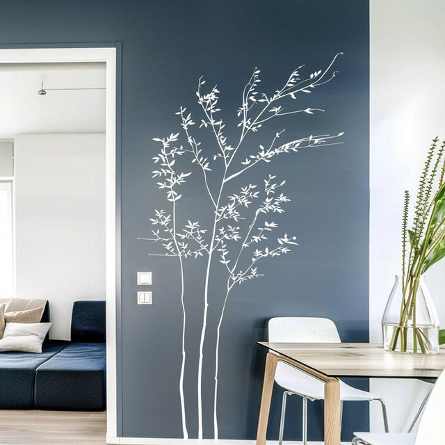Elegant minimalist white branch wall sticker on a dark blue wall, enhancing modern living room decor.