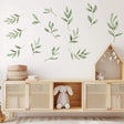 Watercolor leaf wall decals in a nursery, creating a serene, nature-inspired atmosphere with green botanical designs.