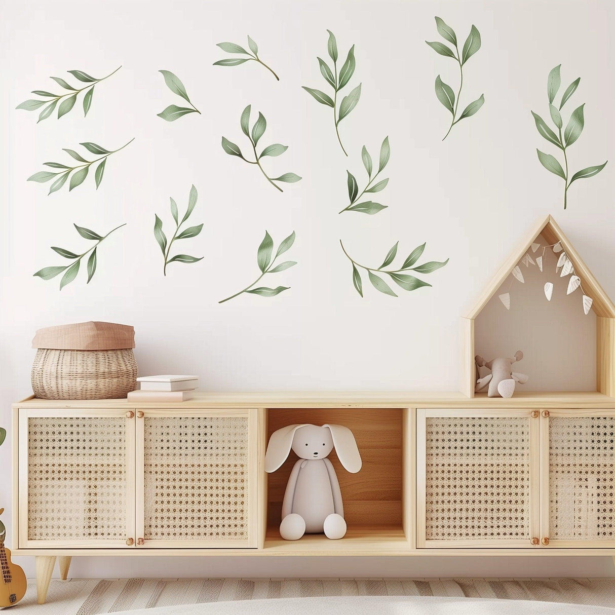 Watercolor leaf wall decals in a nursery, creating a serene, nature-inspired atmosphere with green botanical designs.