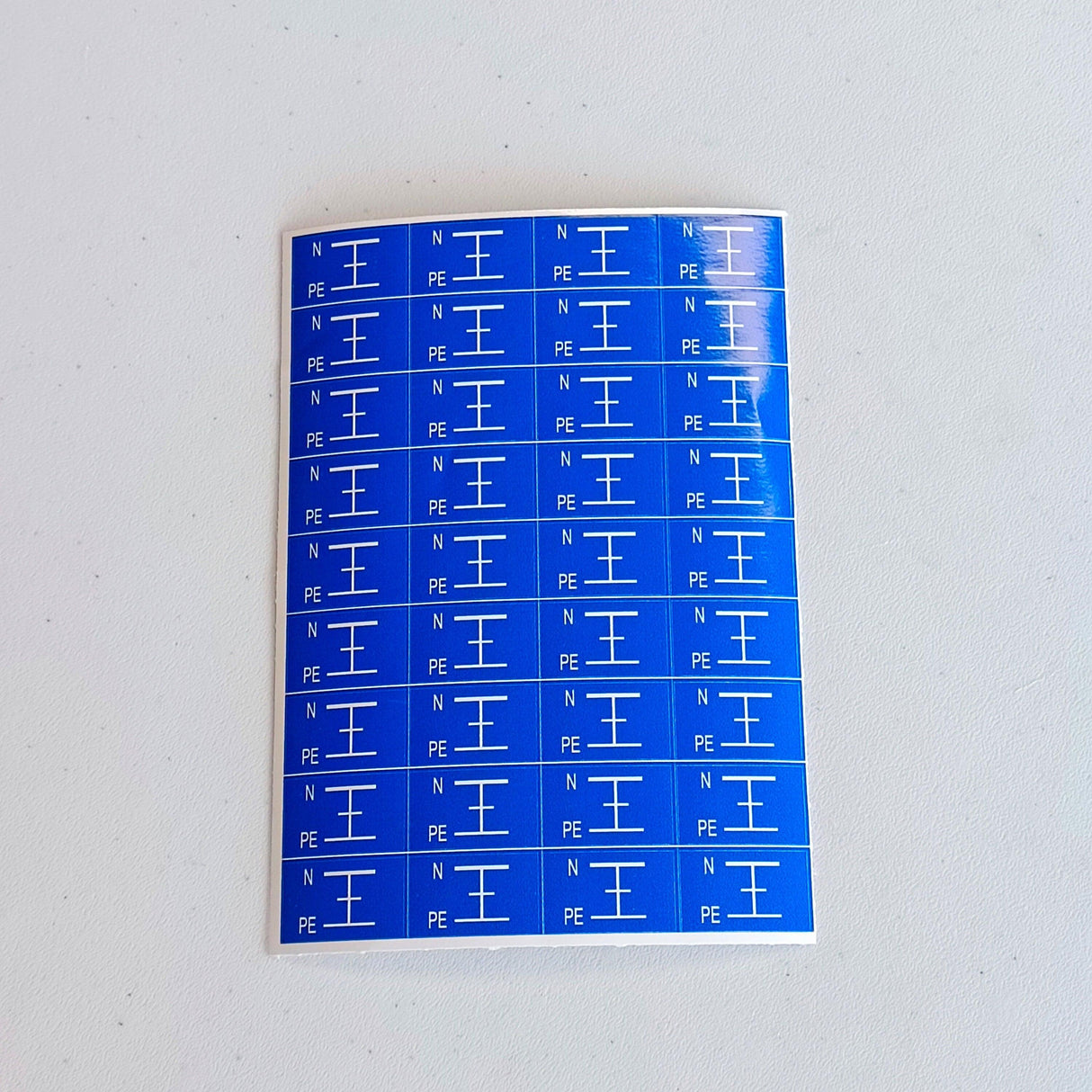 Set of 36 blue electrical component labels with N and PE markings for safety in electrical systems.