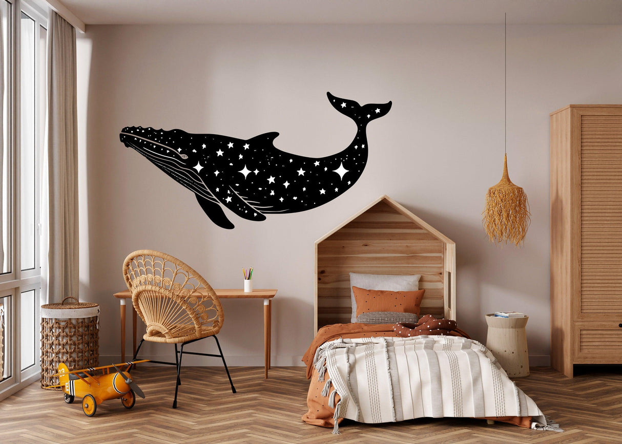 Celestial whale wall sticker in black silhouette with stars, enhancing a whimsical bedroom decor.