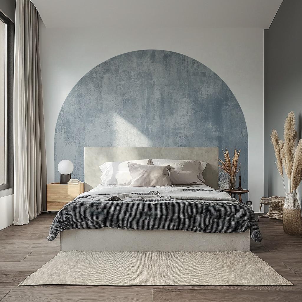 Textured muted blue half circle wall decal above a modern bed, enhancing minimalist bedroom decor.