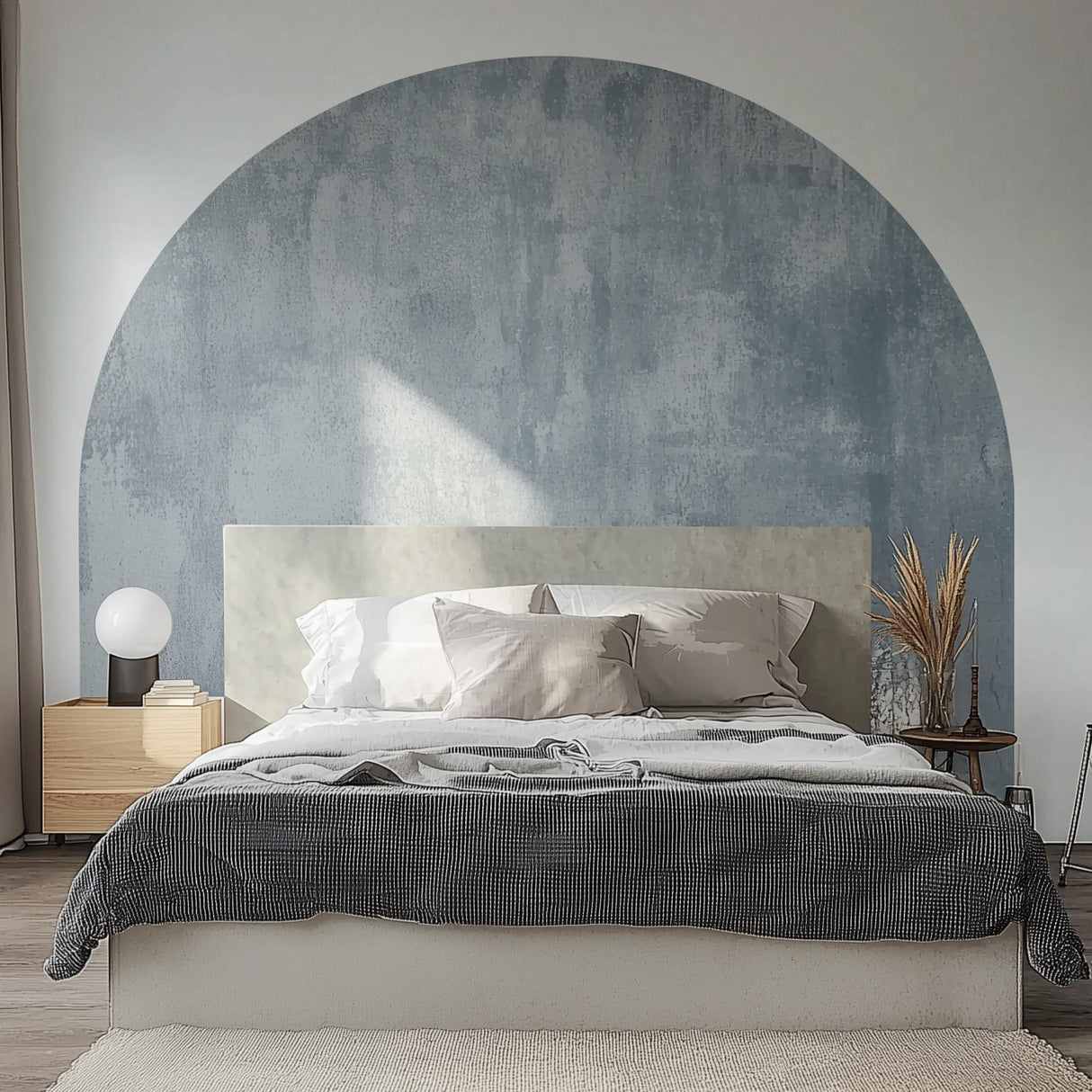 Textured muted blue half circle wall decal above modern bed, creating a stylish and serene bedroom atmosphere.
