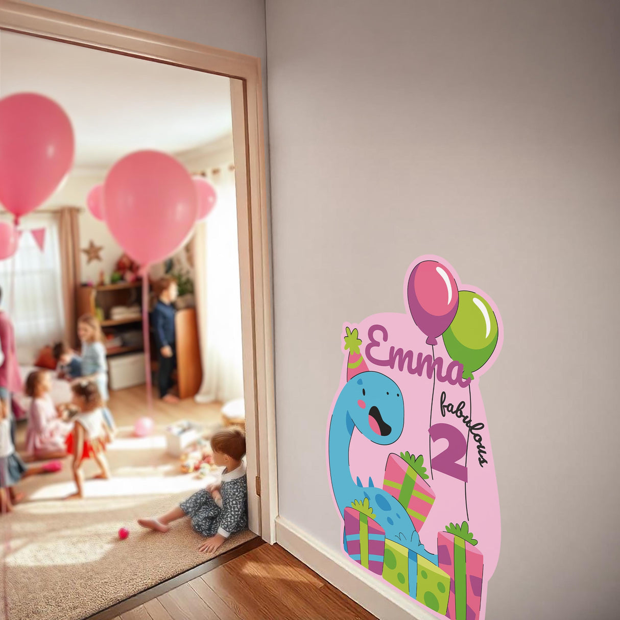 Personalized dinosaur birthday wall sticker featuring Emma, age 2, with balloons and gifts in a festive party setting.