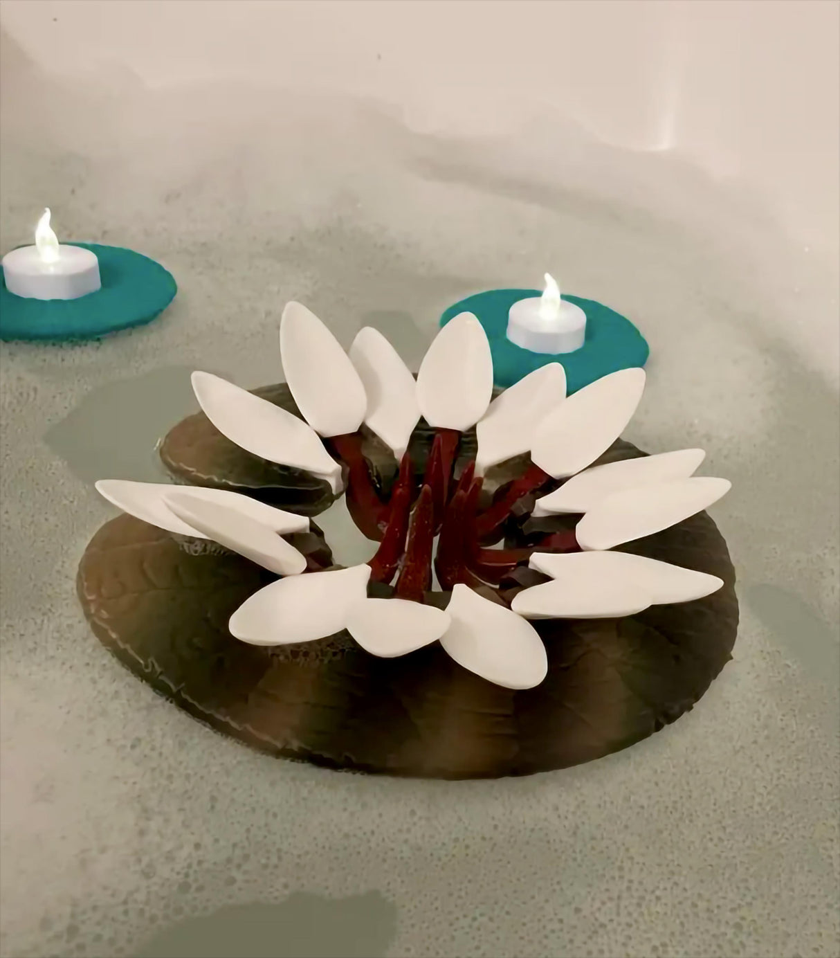 Floating Wine Glass Holder and Candle Holder Lily Pad in a soothing bathtub setting.