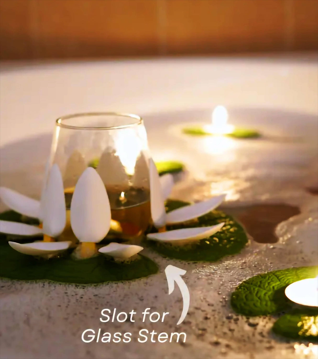 Floating wine glass holder with lotus petals and candle, perfect for enhancing bath time relaxation.