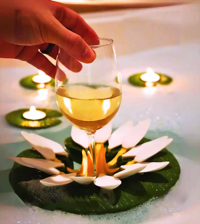 Floating wine glass holder with candles, perfect for a relaxing bath and spa ambiance.