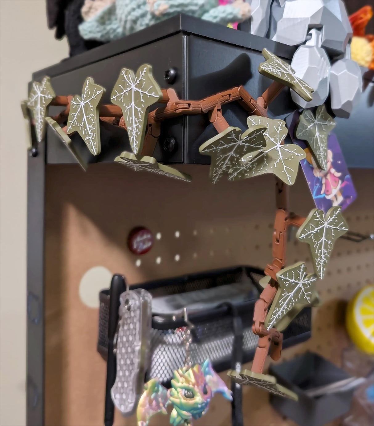 Flexible English Ivy fridge magnet with articulated stems creating a stylish vertical display on a shelf.