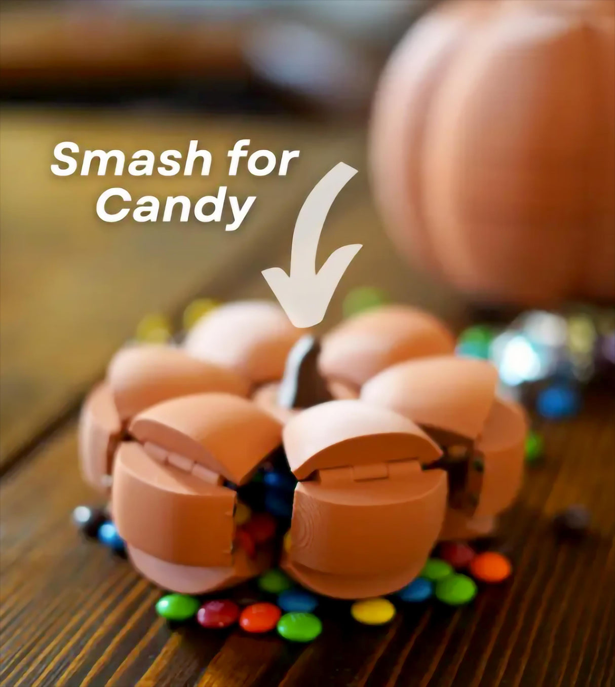 Smack O'Lantern candy bowl showing candy release mechanism with colorful treats around it.