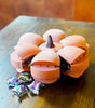 Smack O'Lantern Candy Bowl with segmented pumpkin design and Halloween treats on a wooden table.