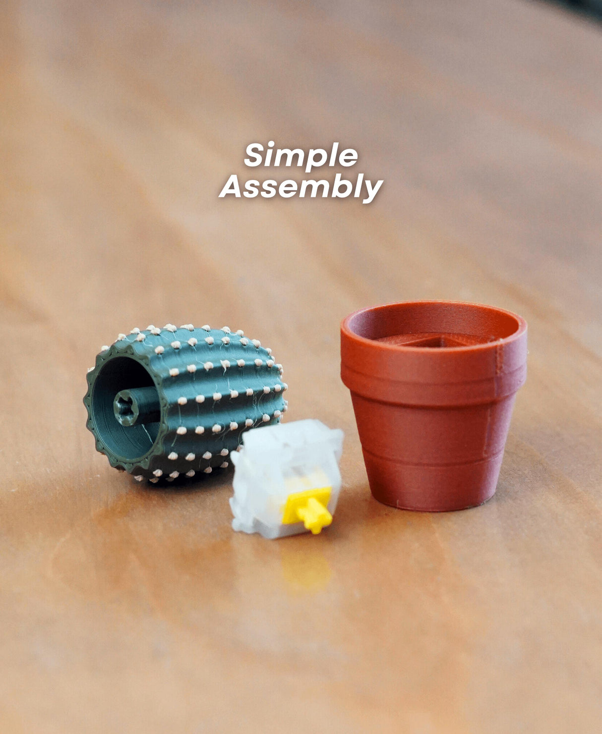 Mini Clickable Cactus parts showing simple assembly of fidget toy and pot on a wooden surface.
