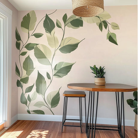 Botanical wall decal featuring green leaves on a light wall, enhancing a modern dining room decor.