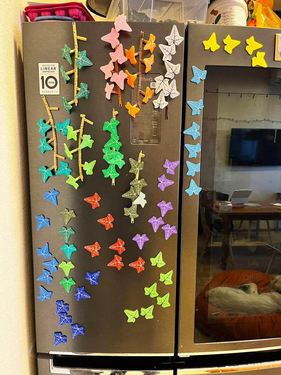 Colorful 3D-printed ivy fridge magnets in various shapes adorning a refrigerator, enhancing kitchen decor.