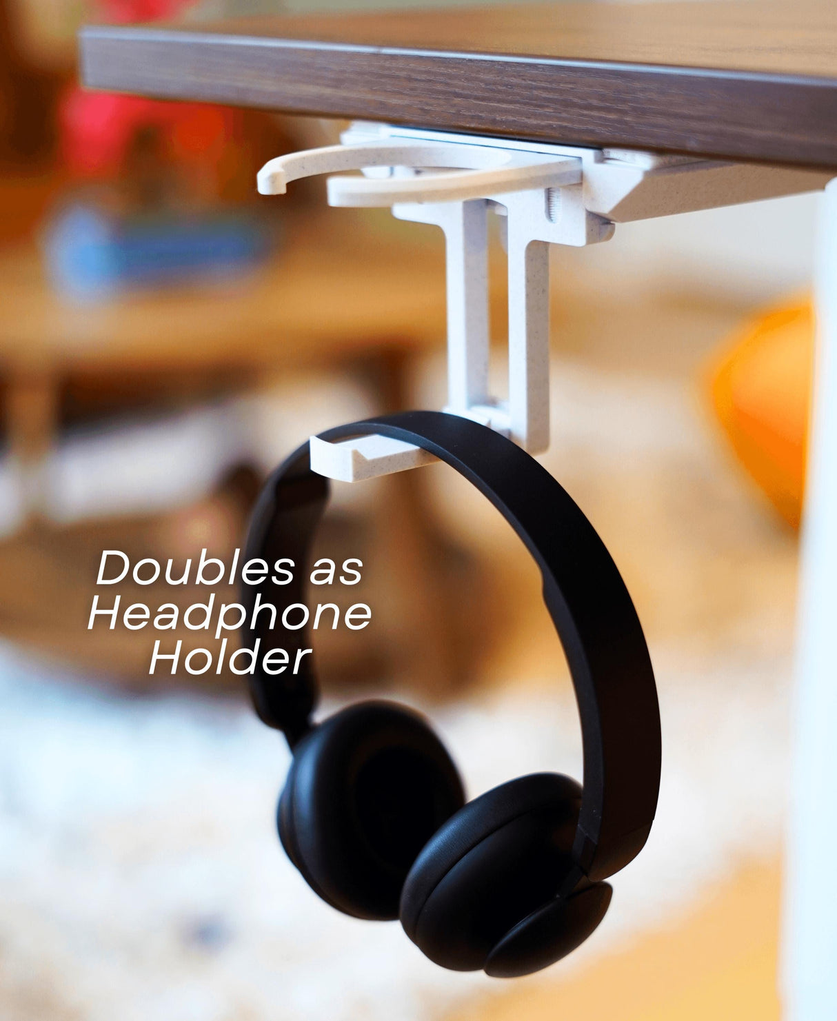 Fold-out under desk cup holder with headphones, featuring minimalist design and dual functionality as a headphone holder.