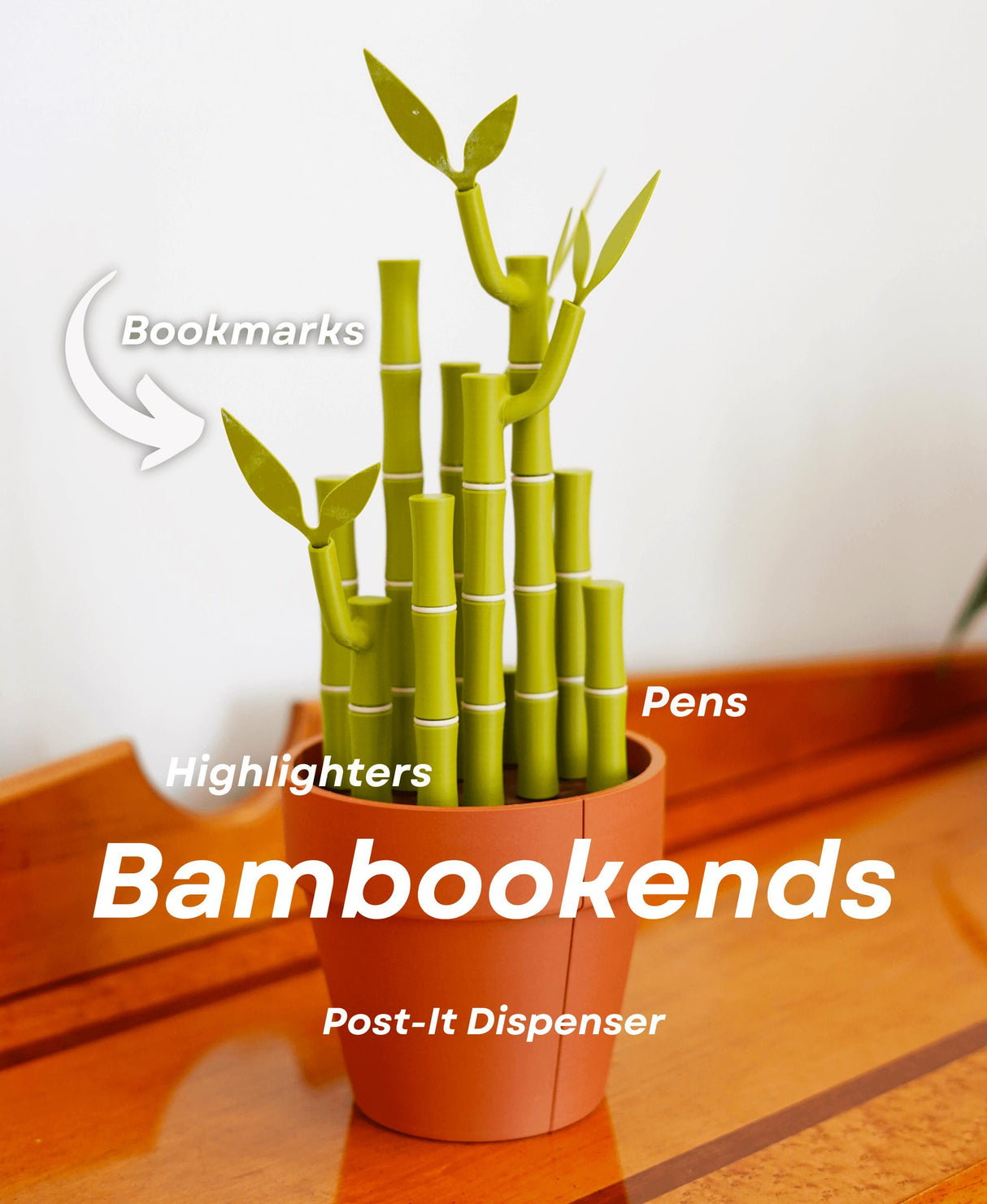 Functional bamboo bookends with pen holder, highlighters, and post-it note dispenser in a stylish pot.