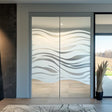 Frosted glass decal with elegant wave design on sliding doors, enhancing privacy and style in a modern space.