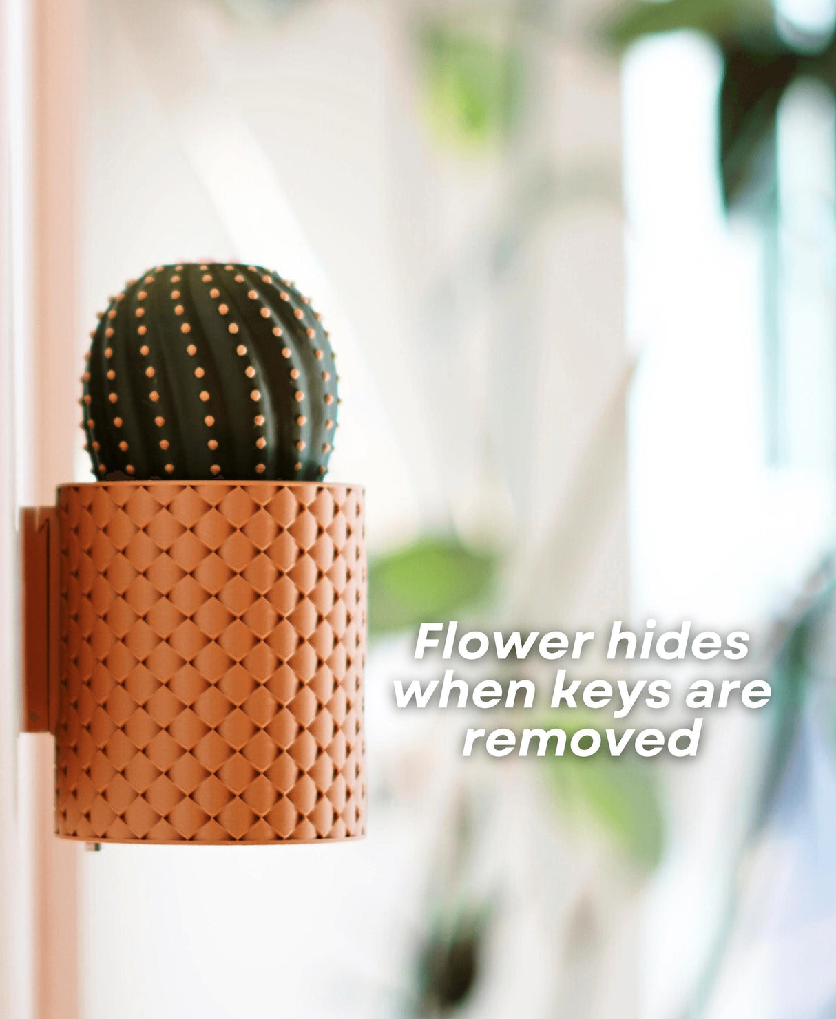 Stylish wall-mounted cactus key holder with flower mechanism that hides when keys are removed.