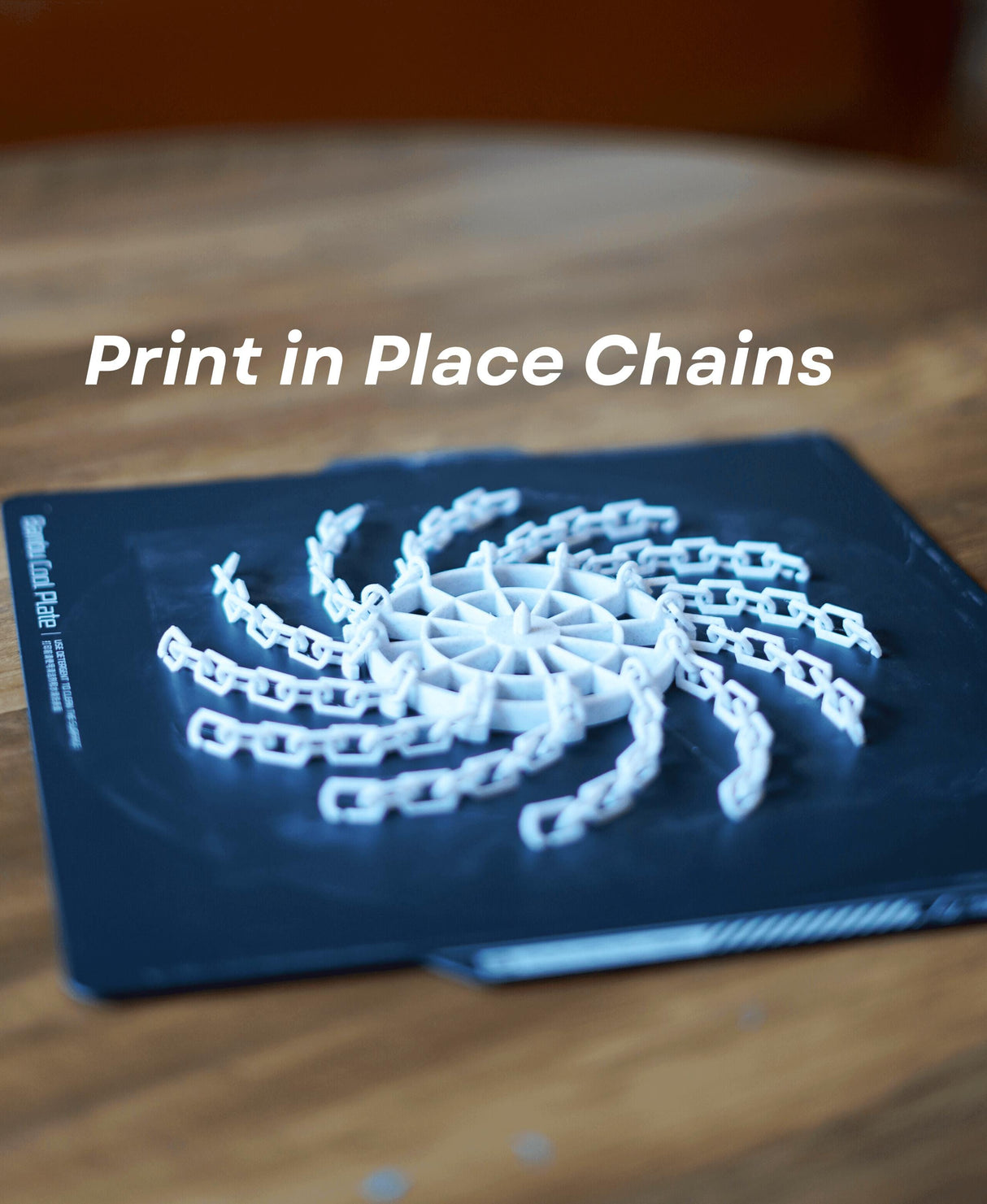 Print in place chains designed for 3D printing, featuring an intricate chain design on a build plate.