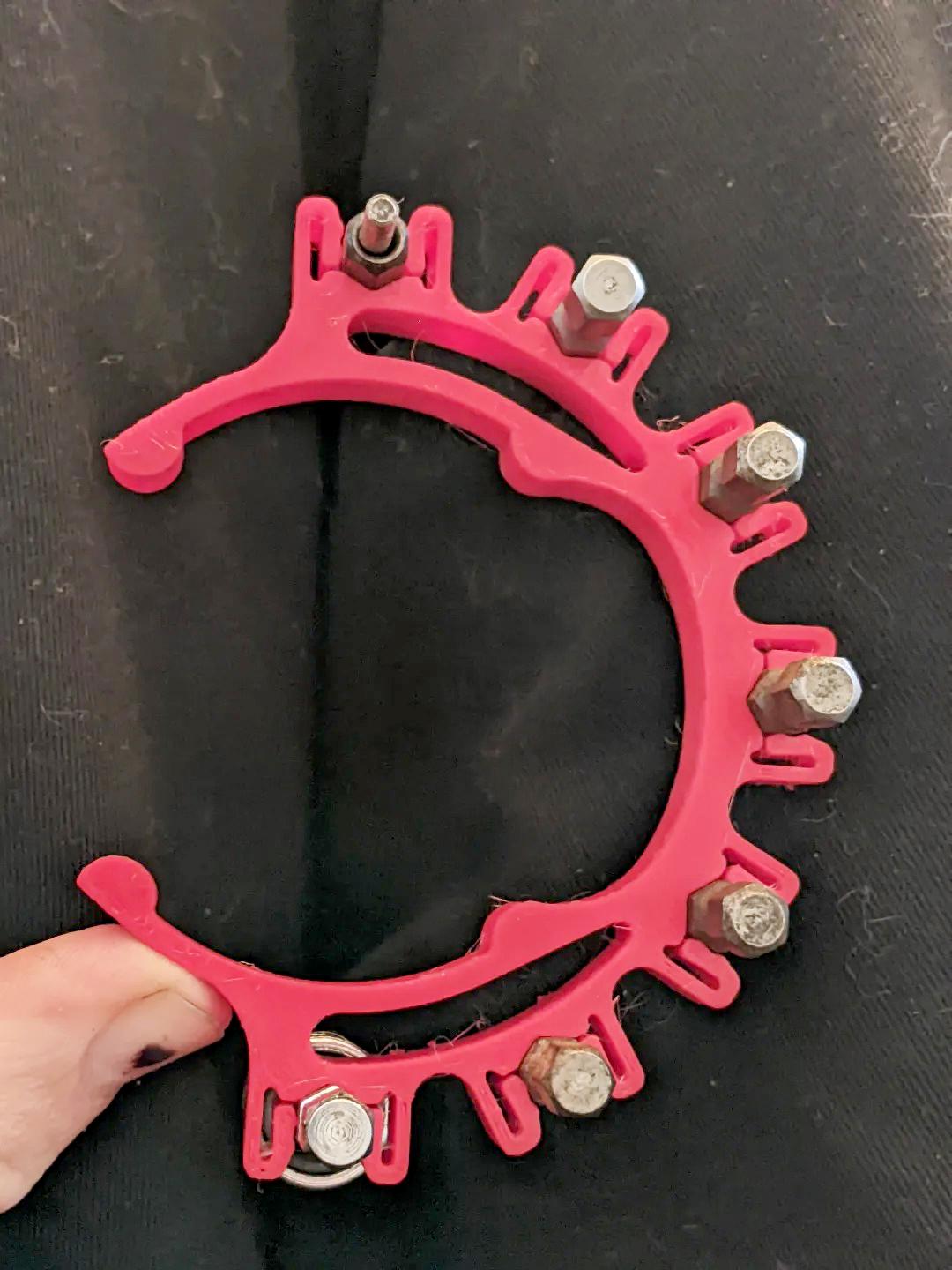 3D-printed drill bit holder clip designed for organizing and securing drill bits during use.