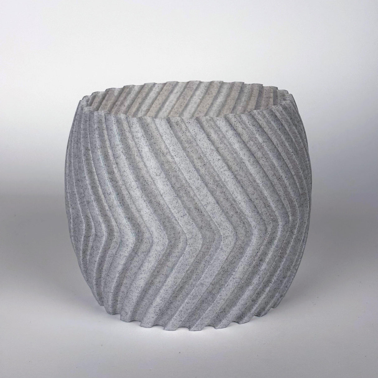 Modern gray zig zag planter cover, stylish 3D-printed decorative pot sleeve for indoor plants.